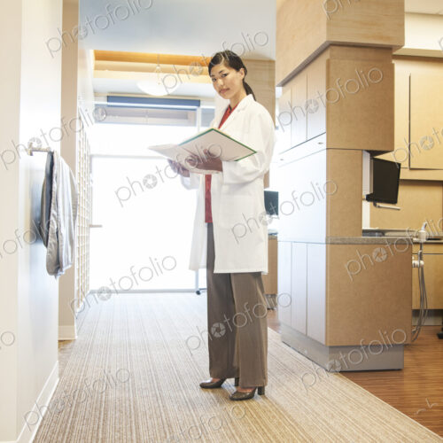 A portrait of an Asian female dentist in her office. A portrait of an Asian female dentist in her office.