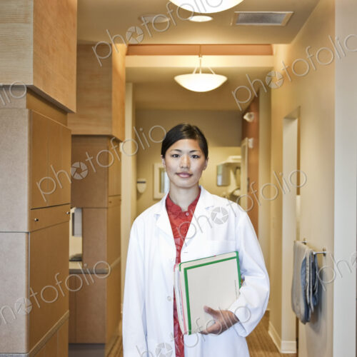 A portrait of an Asian female dentist in her office. A portrait of an Asian female dentist in her office.