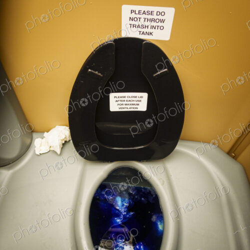 A public restroom toilet cubicle, a toilet at a reststop on a major road.