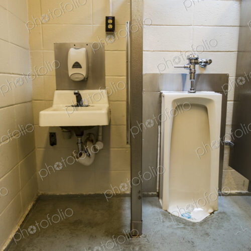 A public restroom urinal, a toilet at a reststop on a major road. A public restroom urinal, a toilet at a reststop on a major road.