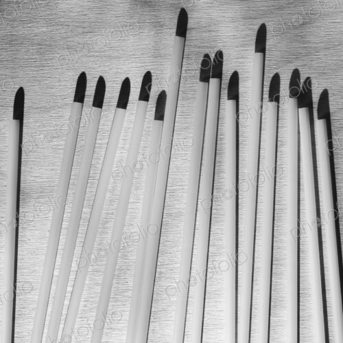 A range of white plastic drinking straws with black tips. A range of white plastic drinking straws with black tips.