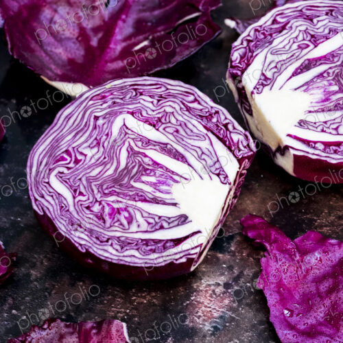 A raw round red cabbage, cut across the middle. A raw round red cabbage, cut across the middle.