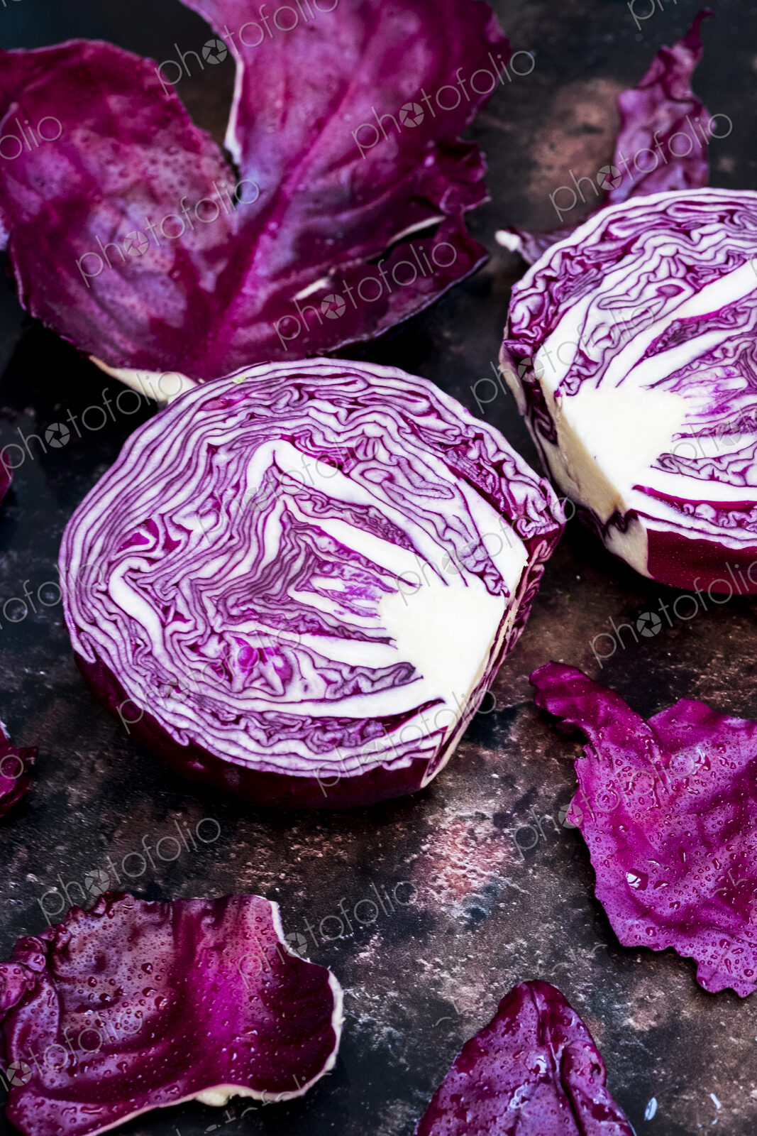 A raw round red cabbage, cut across the middle.