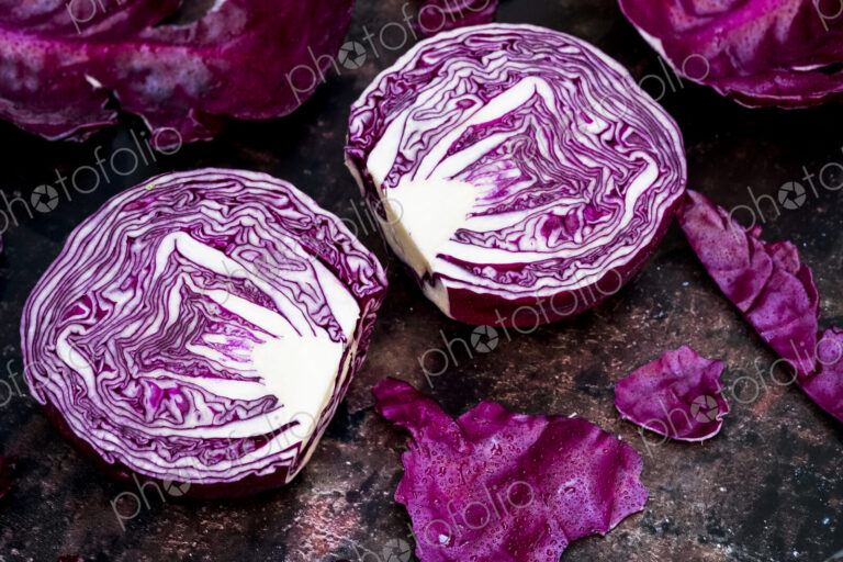 A raw round red cabbage, cut across the middle.
