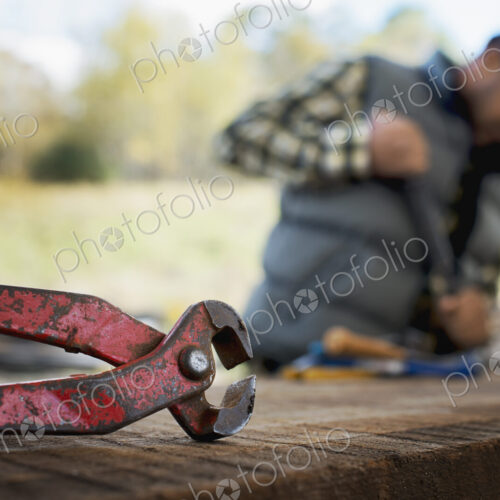 A reclaimed lumber workshop. A man preparing the timber by removing all the nails and… A reclaimed lumber workshop. A man preparing the timber by removing all the nails and…