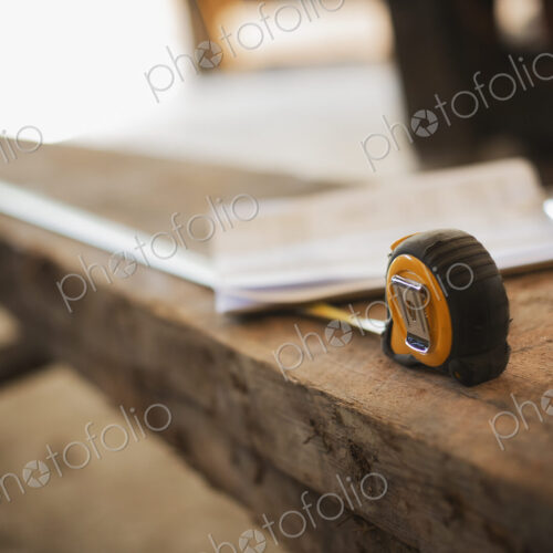 A reclaimed timber yard. Recycled plank of wood, measuring tape and a clipboard with… A reclaimed timber yard. Recycled plank of wood, measuring tape and a clipboard with…