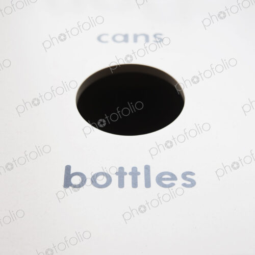 A recycling bin for bottles and cans. A recycling bin for bottles and cans.