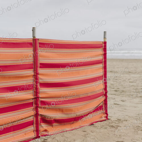 A red striped windbreak on Cannon Beach on the Oregon coast.