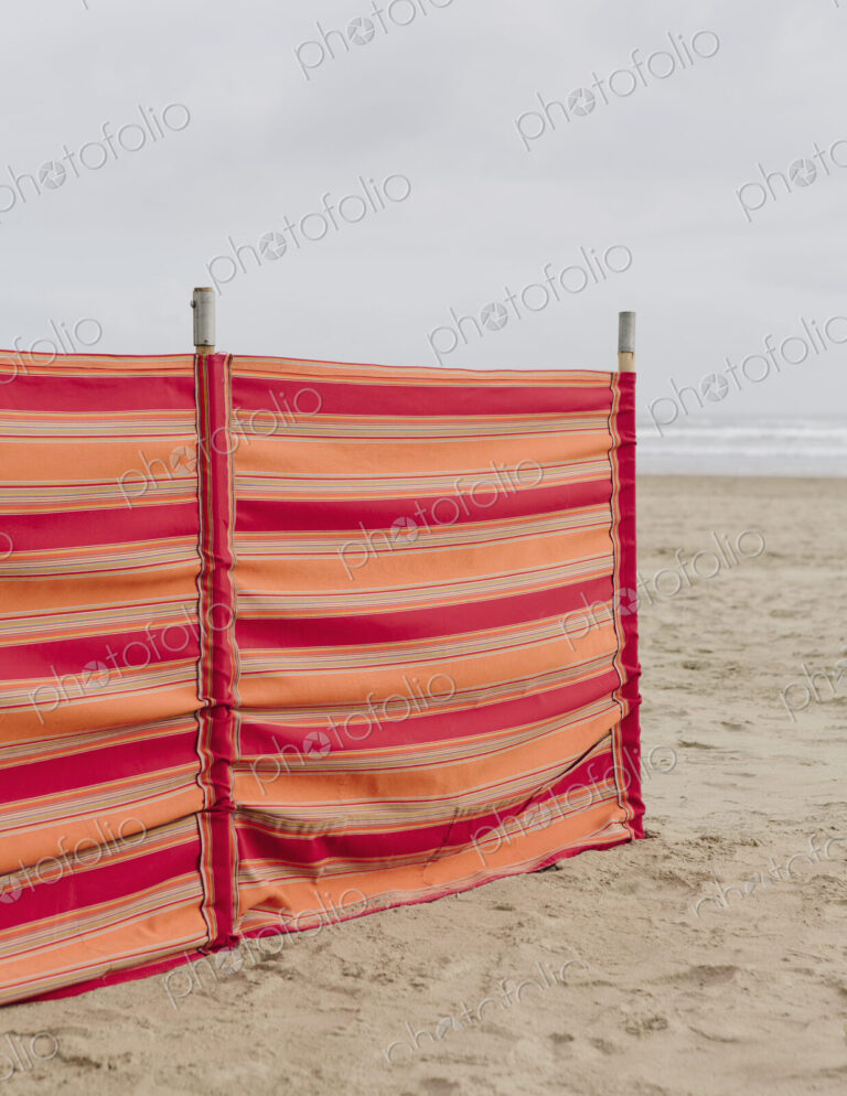 A red striped windbreak on Cannon Beach on the Oregon coast.