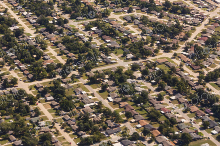 A residential area, an aerial view of the houses, layout and gardens and the roads in…