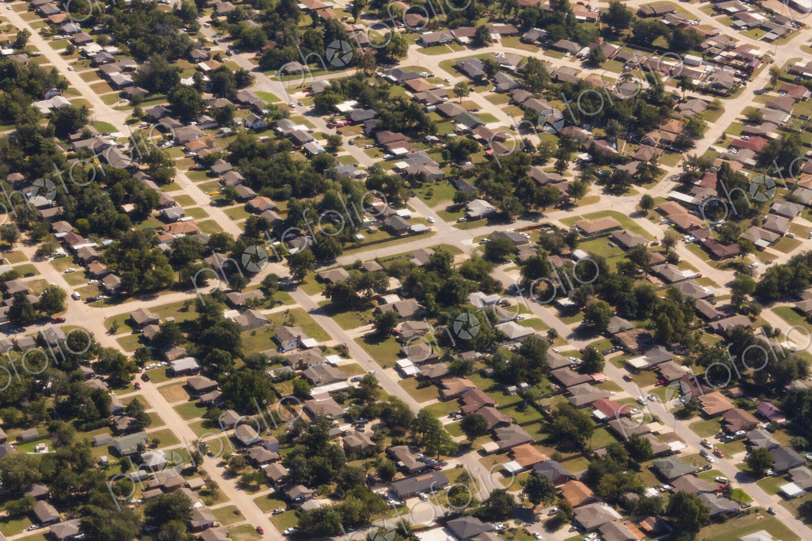 A residential area, an aerial view of the houses, layout and gardens and the roads in…