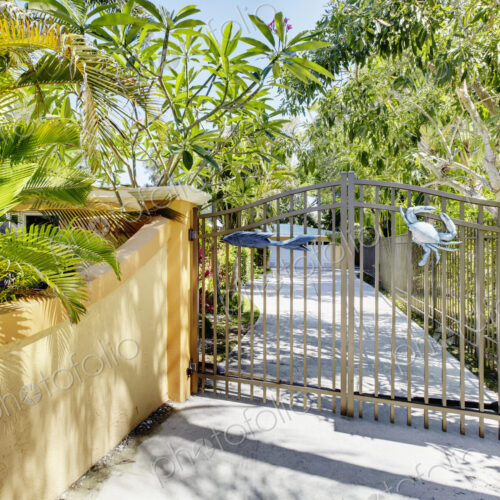 A residential driveway, electric gates and wall A residential driveway, electric gates and wall