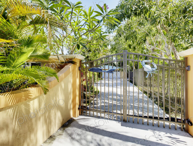 A residential driveway, electric gates and wall