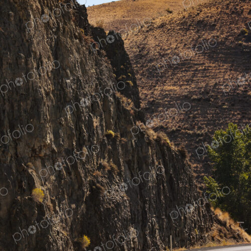 A road through a canyon with steep cliffs.