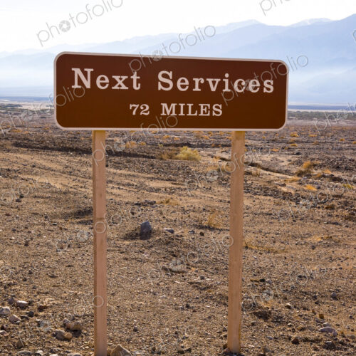 A roadside sign in Death Valley, CA, USA. Next Services 72 Miles. A roadside sign in Death Valley, CA, USA. Next Services 72 Miles.