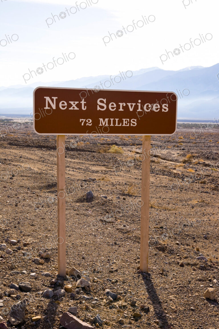 A roadside sign in Death Valley, CA, USA. Next Services 72 Miles.