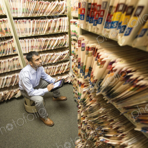 A room full of paper copies of medical files. A room full of paper copies of medical files.