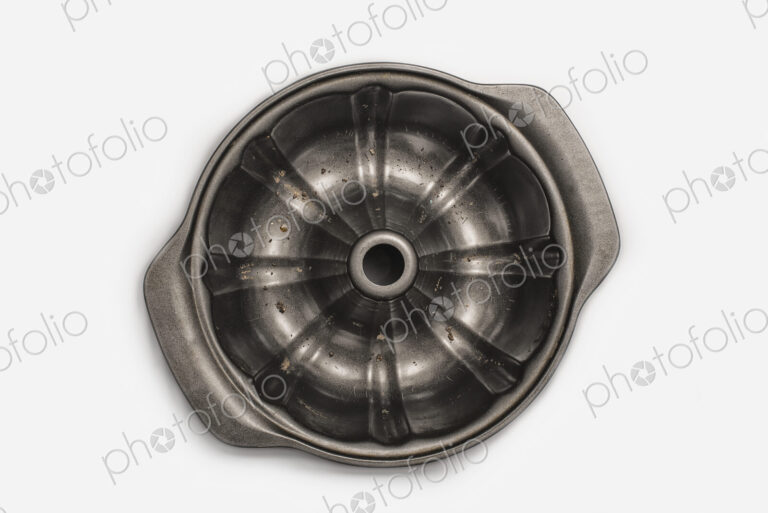 A round metal strainer, or lemon juicer.