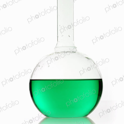 A rounded glass scientific chemical flask with a long funnel neck, holding green liquid. A rounded glass scientific chemical flask with a long funnel neck, holding green liquid.