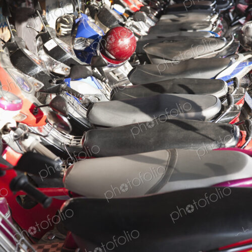A row of parked scooters at Siem Riep Old Market (Psar Chaa), Cambodia. A row of parked scooters at Siem Riep Old Market (Psar Chaa), Cambodia.