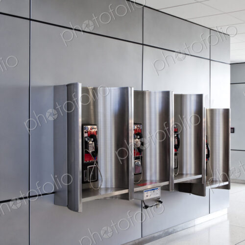 A row of public telephones in booths at an airport. A row of public telephones in booths at an airport.