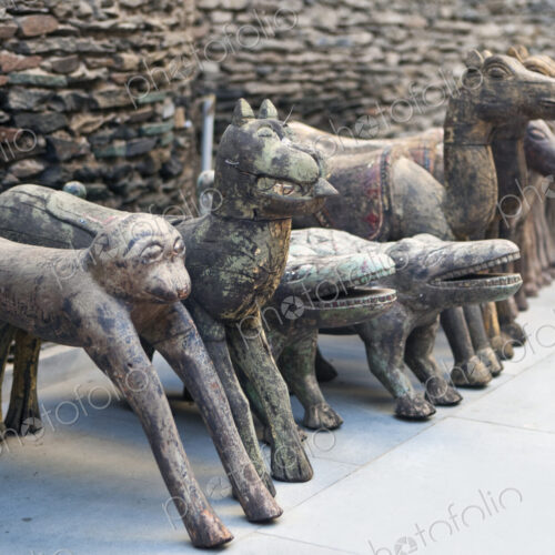 A row of stone sculptures, animals, monkey, crocodile, camel and horses.