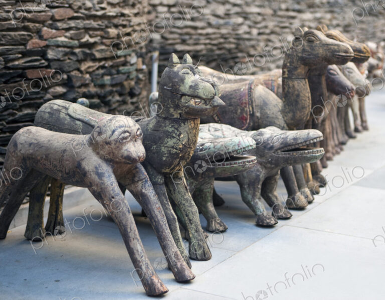 A row of stone sculptures, animals, monkey, crocodile, camel and horses.
