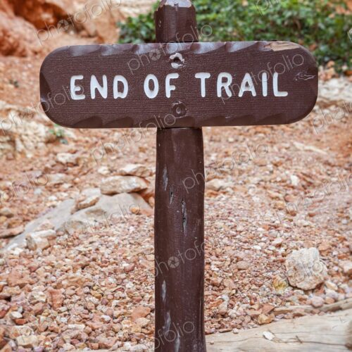 A rustic wooden 'End of Trail' sign marks the conclusion of a hiking path in Bryce… A rustic wooden 'End of Trail' sign marks the conclusion of a hiking path in Bryce…
