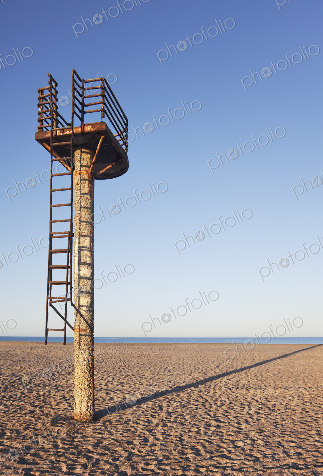 A rusting lifeguard tower on an empty beach early in the morning near Almeria
