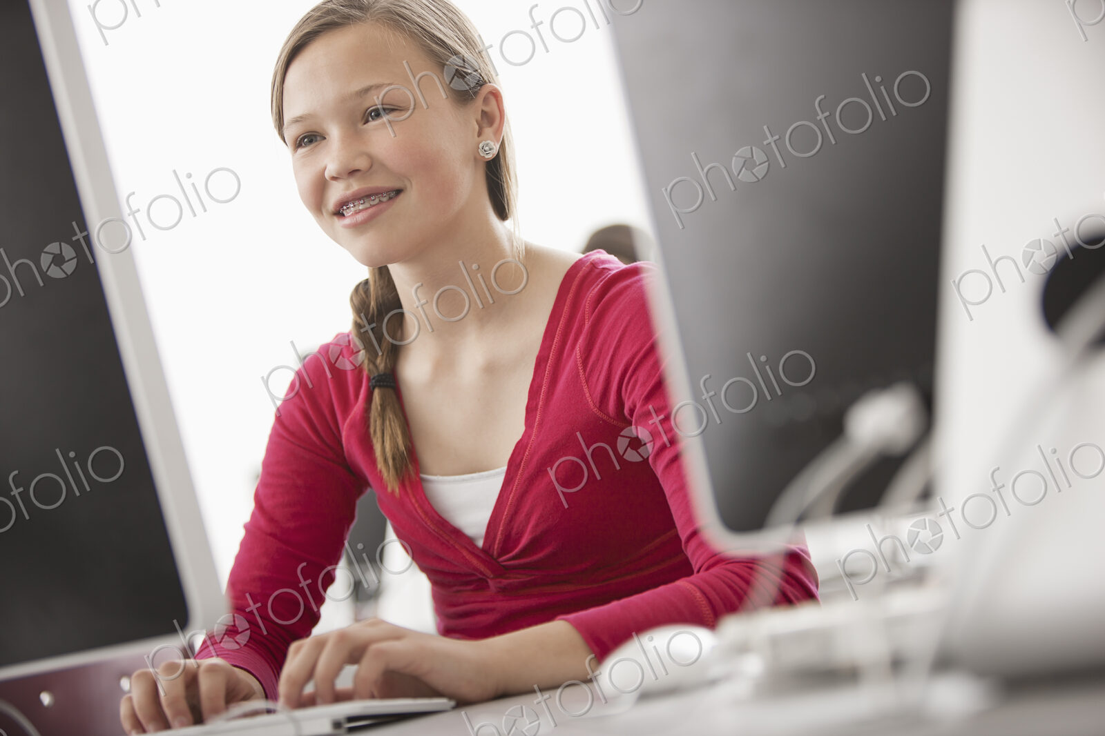 A school room, computer laboratory or lab with rows of computer monitors and seating.…