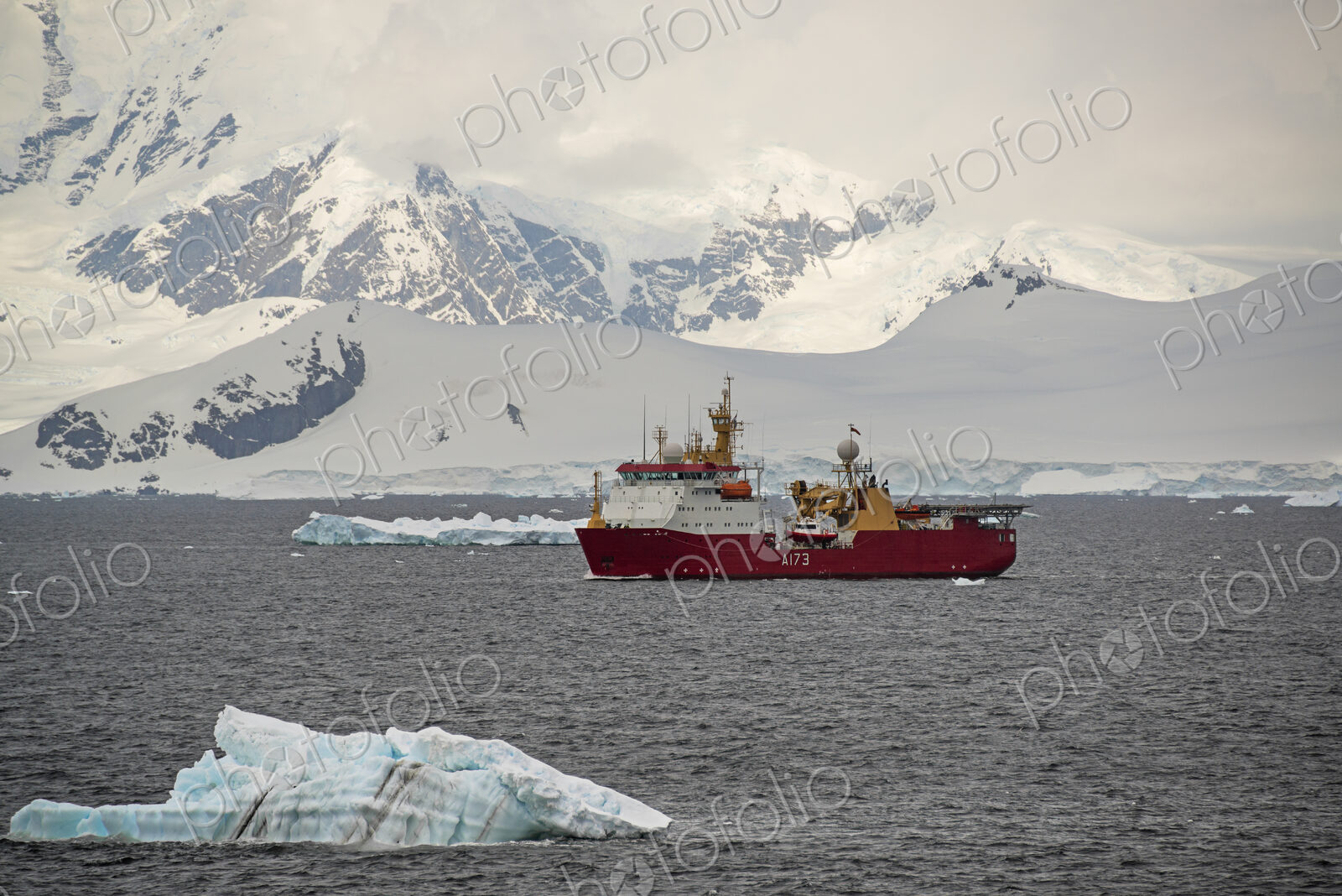 A scientific survery research ship on the water offshore in Antarctica.