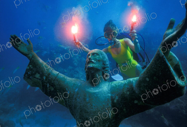 A scuba diver with underwater flares, celebrating the 25th anniversary of the…