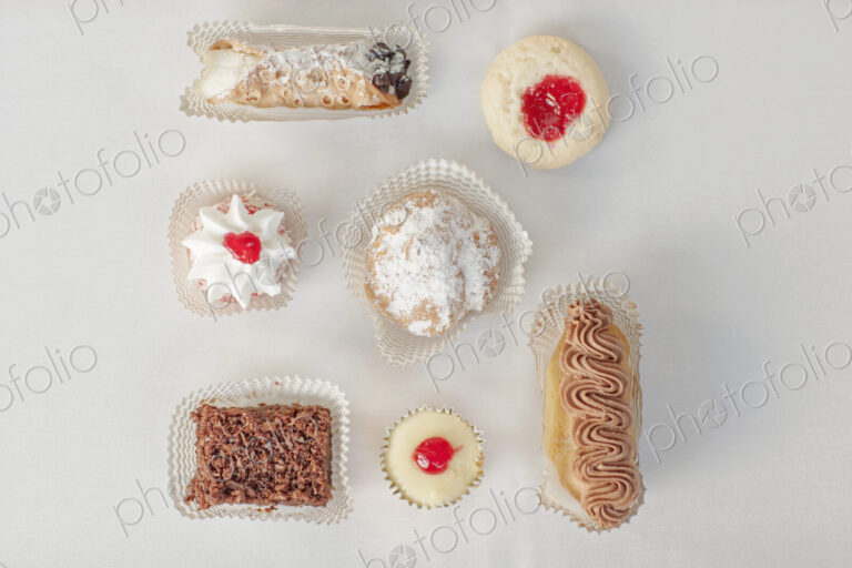 A selection of party desserts, organic food, and dainty cakes and pastries.