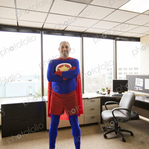 A self satisfied caucasian office super hero in his cubicle office. A self satisfied caucasian office super hero in his cubicle office.