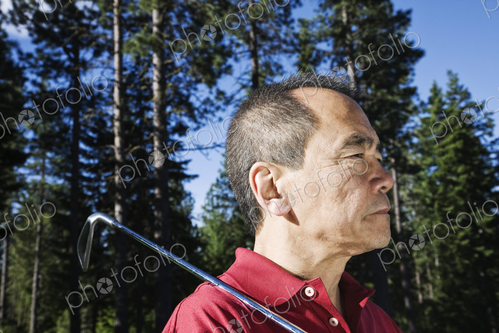 A senior golfer ready to approach the next shot on a golf course.