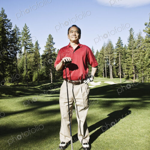 A senior golfer ready to approach the next shot on a golf course. A senior golfer ready to approach the next shot on a golf course.