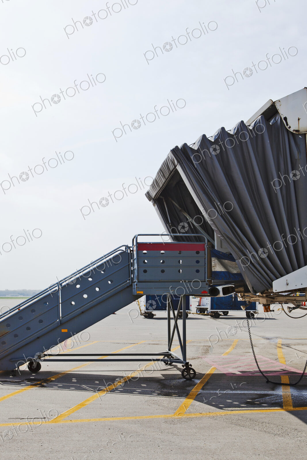 A set of steps and a mobile airport departure passenger tunnel, air bridge