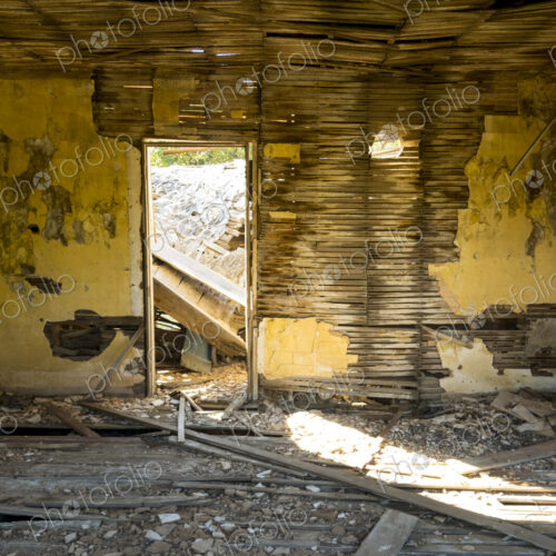 A shell of a building, a derelict house interior, exposed timbers and peeling… A shell of a building, a derelict house interior, exposed timbers and peeling…