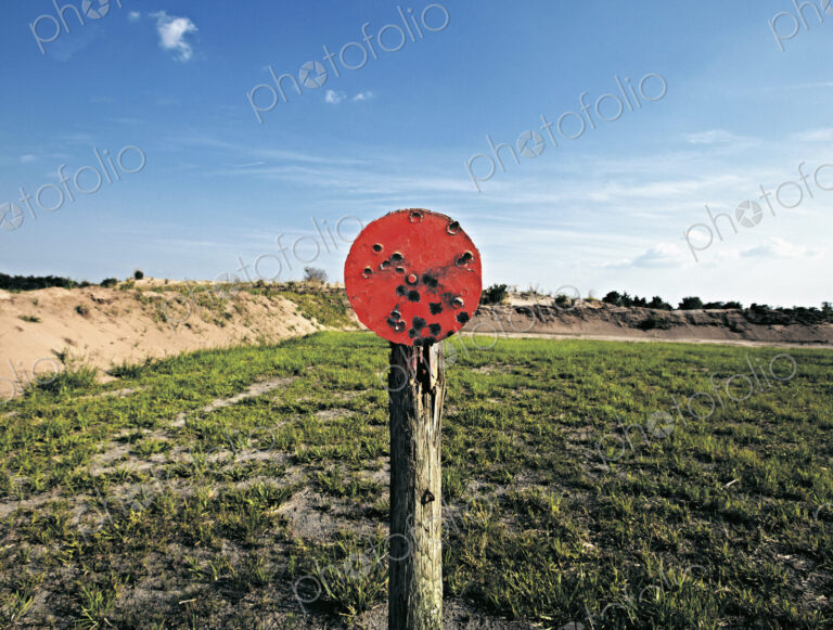 A shooting range target with bullet holes.