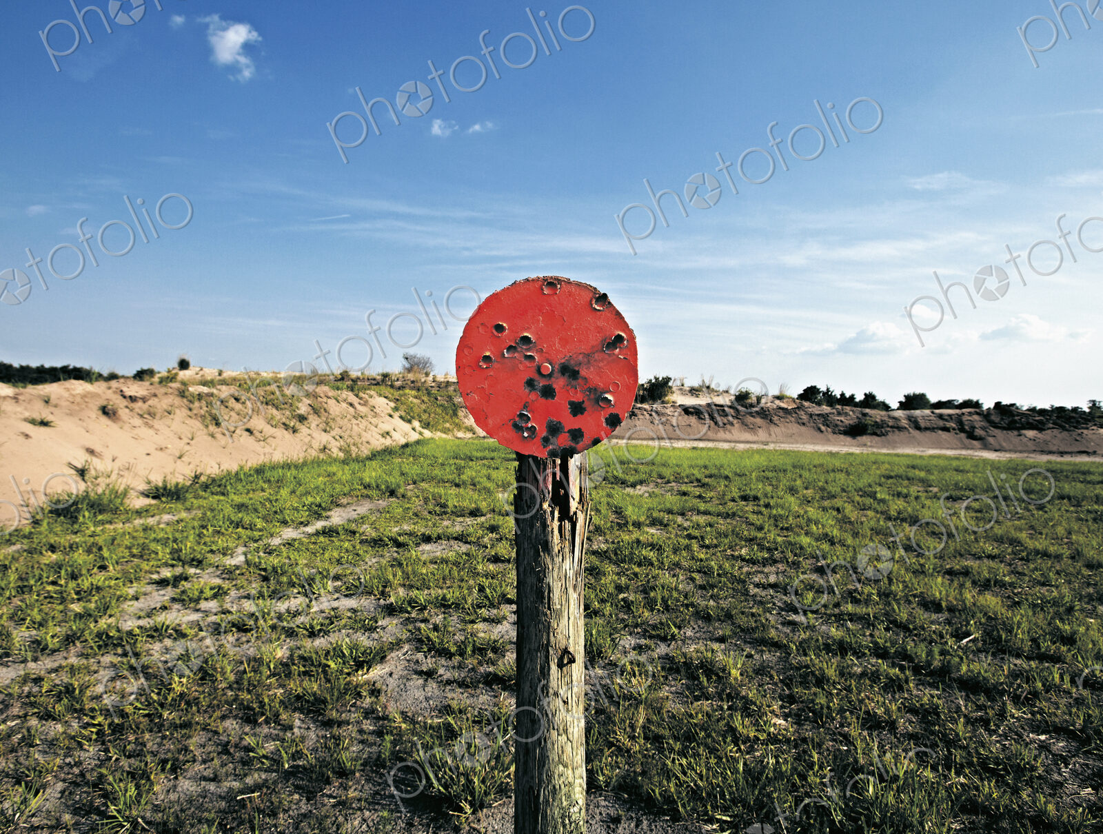 A shooting range target with bullet holes.