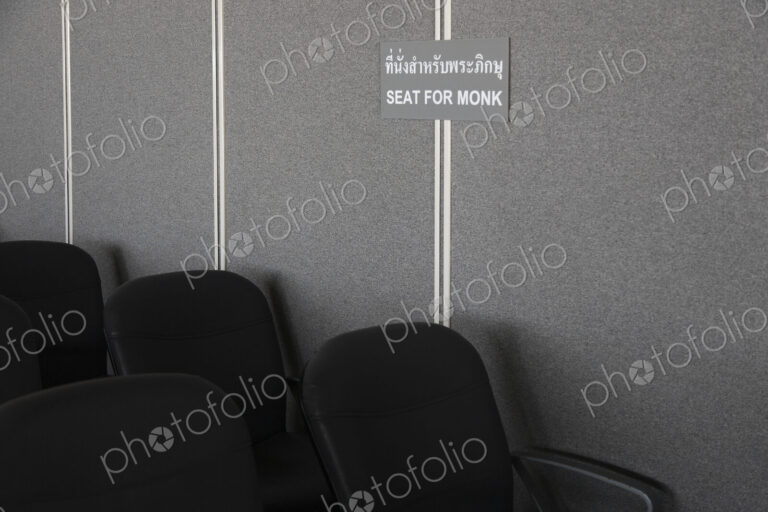 A sign in the waiting area of the airport, Seat reserved for monks.