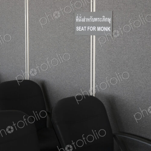 A sign in the waiting area of the airport at Ko Lanta. Reserved seats for monks.