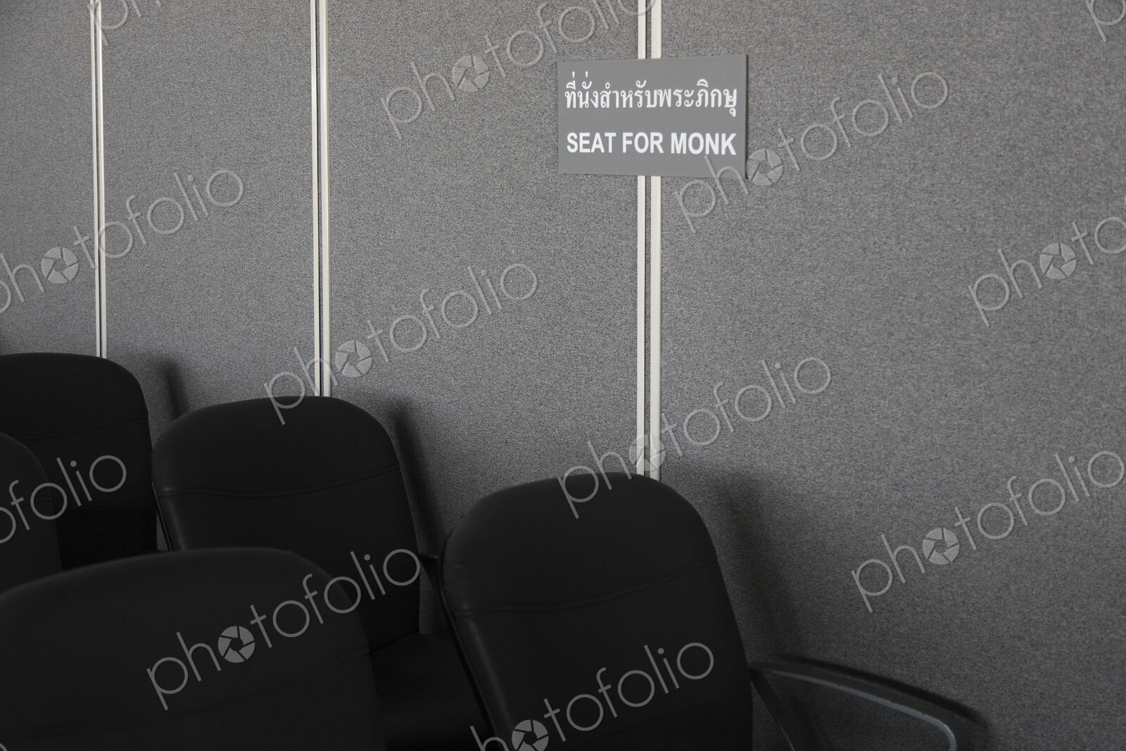 A sign in the waiting area of the airport at Ko Lanta. Reserved seats for monks.