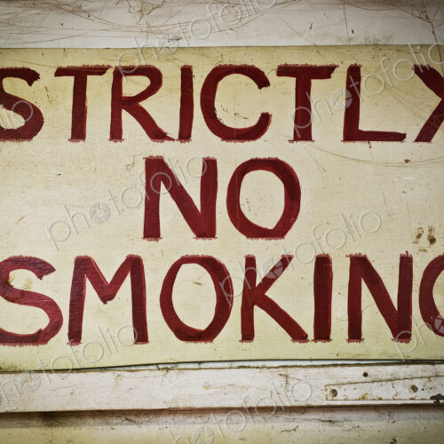 A sign saying Strictly No Smoking on the wall of a furniture maker;s workshop.
