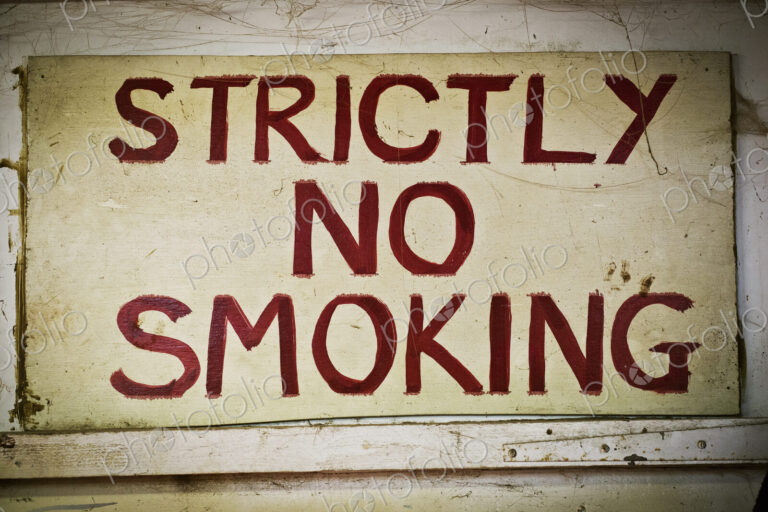 A sign saying Strictly No Smoking on the wall of a furniture maker;s workshop.