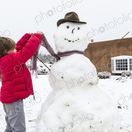 A six year old boy building a snowman A six year old boy building a snowman