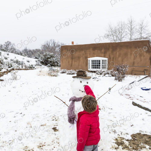 A six year old boy building a snowman A six year old boy building a snowman