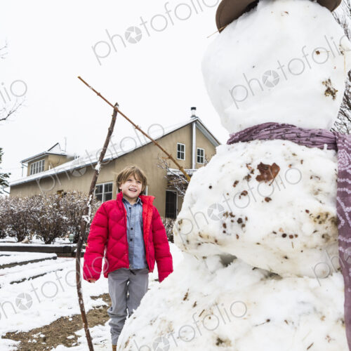 A six year old boy building a snowman A six year old boy building a snowman