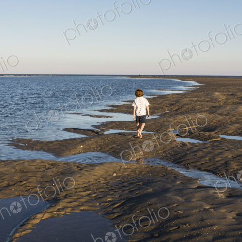 A six year old boy investigating sandy landscape A six year old boy investigating sandy landscape