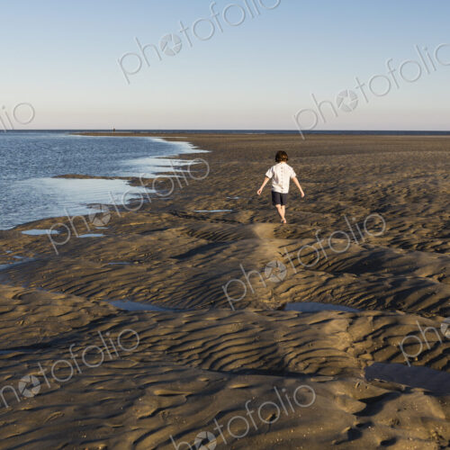 A six year old boy investigating sandy landscape A six year old boy investigating sandy landscape